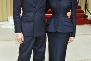 WPA Pool/Getty Images Entertainment/Getty Images Designer Stella McCartney wears a chic black suit with husband Alasdhair Willis to Buckingham Palace in London.