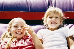 Digital Vision./Photodisc/Getty Images Bouncy castles offer hours of fun, but extremely young children need constant supervision when jumping.