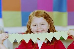 Katy McDonnell/Digital Vision/Getty Images Make garlands and strings of paper hearts for a Valentine craft to decorate the house on Valentine's Day.
