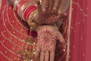 Creatas/Creatas/Getty Images Muslim brides in the Asian subcontinent often have henna tattoos painted on their hands and feet for the wedding ceremony.