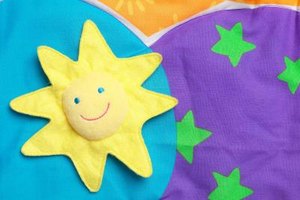 Hemera Technologies/Photos.com/Getty Images Prewash your newborn's toys with warm soap and water, followed by a sanitizing solution of diluted bleach.