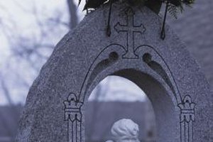 Hemera Technologies/AbleStock.com/Getty Images Flowers, either real or silk, can add a touch of color and beauty to headstones and cemetery markers.