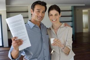Jupiterimages/Pixland/Getty Images Contracts for the sale of a property outline all the specifics, obligations, exceptions and time frames for the sale.