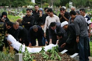 Don Arnold/Getty Images News/Getty Images In a Muslim funeral in Australia, the deceased is buried in white cotton shroud, according to custom.