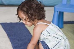 Jupiterimages/Comstock/Getty Images Rolling a ball helps your toddler learn to coordinate her hands and eyes as she tracks its movement.