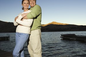 Couple embracing on dock at dusk