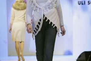 Andreas Rentz/Getty Images Entertainment/Getty Images Actress Barbara Auer models straight-leg jeans and a long, belted cardigan at a charity fashion show in Germany.