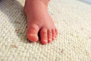 Thinkstock/Comstock/Getty Images Stretching and strengthening exercises can help make it easier for your toddler to walk with flat feet.