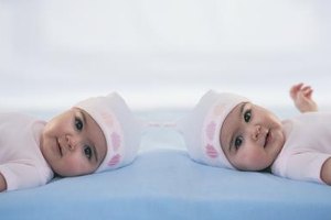 Digital Vision./Photodisc/Getty Images Presenting an older sister with a gift when her twin siblings arrive can eliminate feelings of jealousy.
