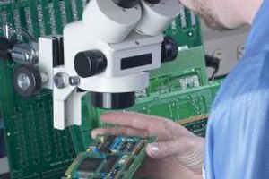 Hemera Technologies/AbleStock.com/Getty Images Electronic engineers work in labs, offices and manufacturing environments, depending on their specialty.