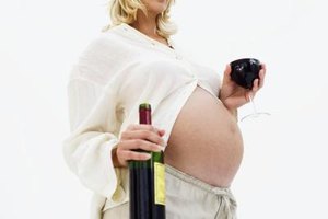 Stockbyte/Stockbyte/Getty Images Alcohol interferes with a baby's brain development, especially in the first three months of pregnancy.