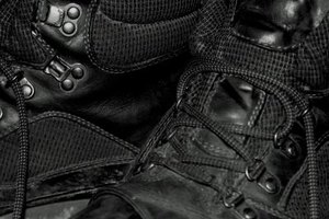 Jupiterimages/Photos.com/Getty Images Black combat boots come in a variety of fabric, but are most commonly made of leather or faux-leather.