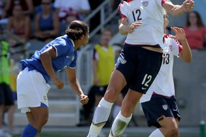 La delantera Abby Wambach cabecea el balón lejos de las jugadoras de Brasil.