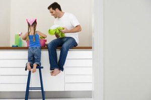 Jupiterimages/Polka Dot/Getty Images Making shared activities, even chores, about quality time with your child will motivate her to cooperate.