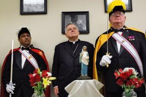 Joe Raedle/Getty Images News/Getty Images The Miami archbishop is flanked by two members of the Knights of Columbus, a Catholic fraternal order.