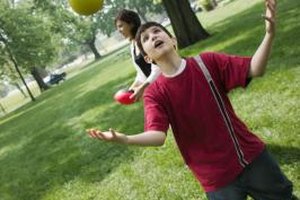 Jupiterimages/liquidlibrary/Getty Images While an older child might be able to learn to juggle with balls, scarves are more appropriate for a kindergartner.