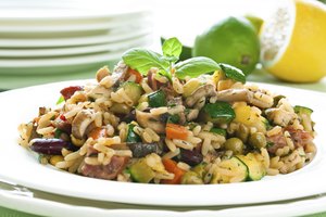 Plato de arroz integral con risotto, pollo, frijoles y verduras.