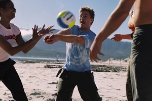Para pasar en el voleibol, mantén los brazos derechos frente a ti, con las manos entrelazadas.