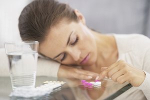 closeup on stressed young woman playing with pills