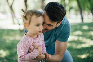 Gentle man holding baby girl
