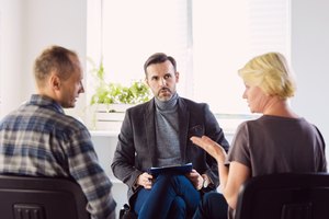 Psychotherapist talking with troubled couple