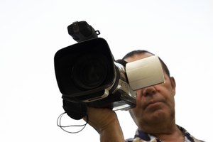 cameraman(focus point on the camcorder) image by Alexey Klementiev from Fotolia.com Include