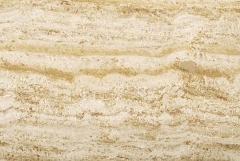 Buff travertine the same way you would marble flooring.