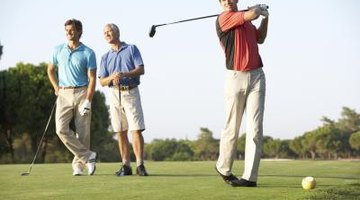 Three men playing golf