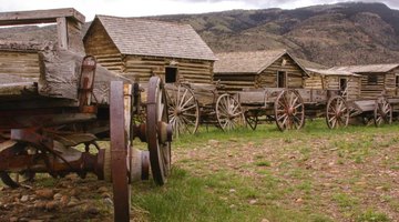 A row of cabins and wagons at a historic site along the Oregon Trail.