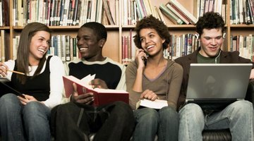 Group of smiling high school students in library.