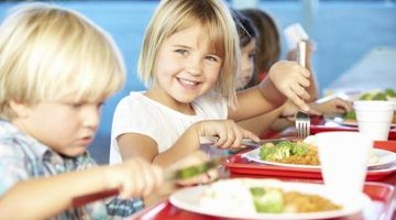 Use a reward system to manage behavior in an elementary school lunchroom.