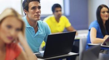 College student in classroom with open computer.