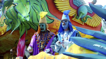 People dressed in costume on a Mardi Gras themed float.