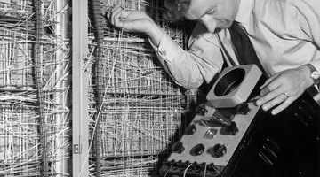 Man working on early electronic computer