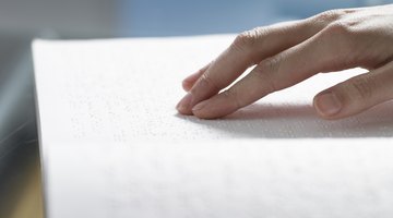 Hand reading braille.