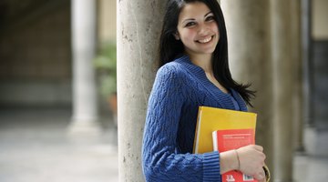 College student holding books on campus