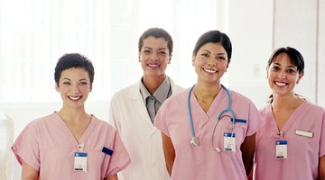 Smiling nurses standing in front of doctor