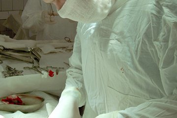 An ER doctor performs surgery. An ER doctor performs surgery.