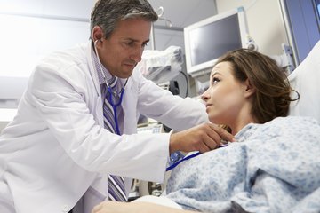 Doctor listening to patients heart Doctor listening to patients heart