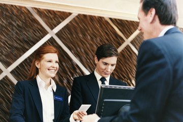 Woman greeting customer at hotel Woman greeting customer at hotel