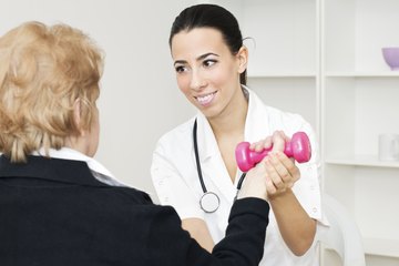 Nurse helping patient lift a weight Nurse helping patient lift a weight