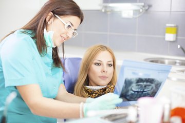 Dental hygenist with her patient Dental hygenist with her patient