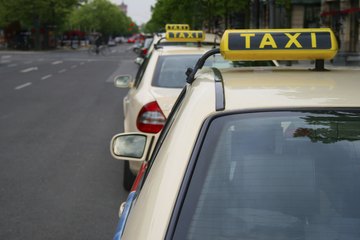 Taxi cars on the side of the road Taxi cars on the side of the road