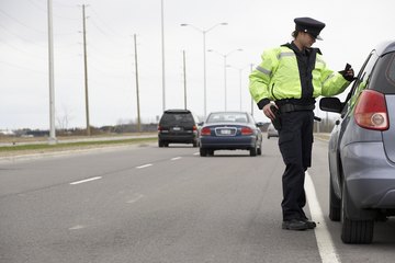 A female officer talks with a driver. A female officer talks with a driver.