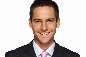 Young man smiling wearing a suit. Young man smiling wearing a suit.