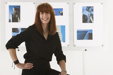 An artist is standing in front of her work. An artist is standing in front of her work.