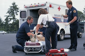 EMT treating a patient on the scene EMT treating a patient on the scene