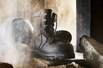 Steel toed industril boots on broken concrete Steel toed industril boots on broken concrete