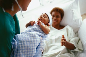 Healthy newborn being brought to mom by neonatal nurse Healthy newborn being brought to mom by neonatal nurse