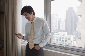 Man in suit looking at his smartphone. Man in suit looking at his smartphone.